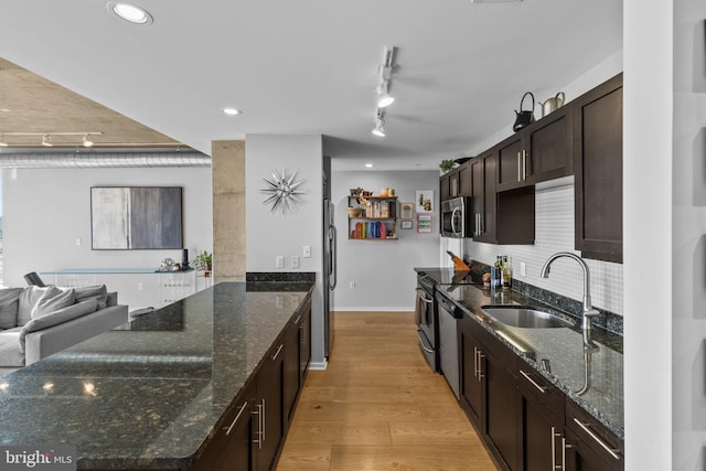 1200 Steuart St Unit 326, Baltimore, MD 21230 - kitchen with stainless steel microwave, a sink, dark brown cabinetry, freestanding refrigerator, and light wood-style floors