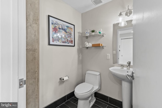 1200 Steuart St Unit 326, Baltimore, MD 21230 - bathroom featuring tile patterned flooring, toilet, baseboards, and a sink