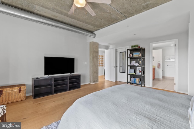 1200 Steuart St Unit 326, Baltimore, MD 21230 - bedroom with wood finished floors, baseboards, and connected bathroom