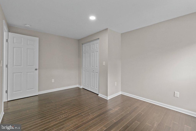 101 Poppleton St, Baltimore, MD 21201 - unfurnished bedroom with baseboards, dark wood-style floors, recessed lighting, and a closet