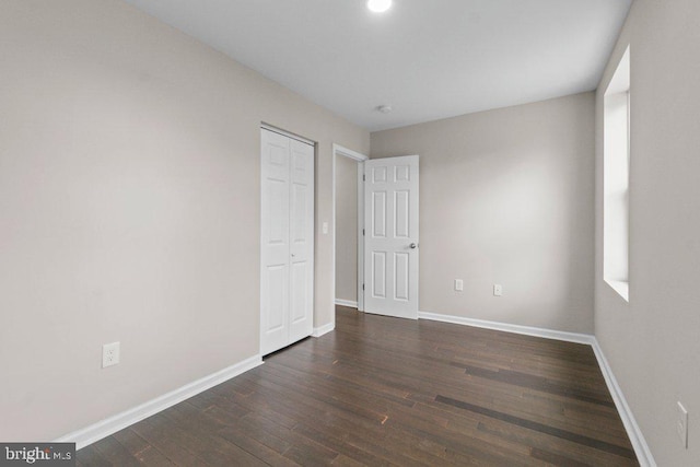 101 Poppleton St, Baltimore, MD 21201 - unfurnished bedroom with wood finished floors, baseboards, and a closet