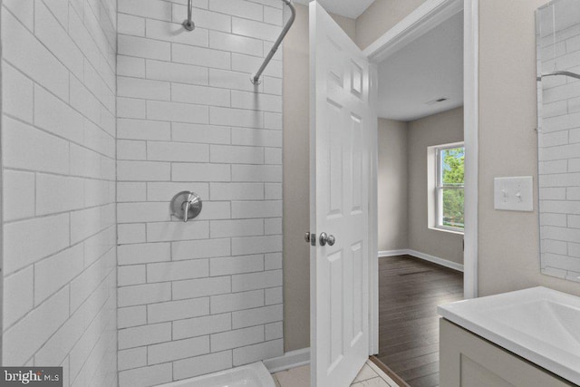 101 Poppleton St, Baltimore, MD 21201 - bathroom featuring tiled shower, baseboards, and vanity