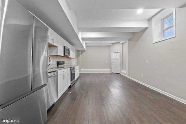 101 Poppleton St, Baltimore, MD 21201 - kitchen with stainless steel appliances, baseboards, white cabinetry, dark wood finished floors, and light stone counters
