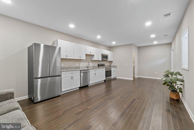 101 Poppleton St, Baltimore, MD 21201 - kitchen with stainless steel appliances, baseboards, white cabinetry, recessed lighting, and dark wood-style floors