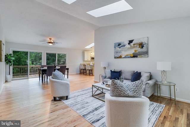 830 Willow Way, Prince Frederick, MD 20678 - living area with lofted ceiling, light wood-style floors, a skylight, and baseboards