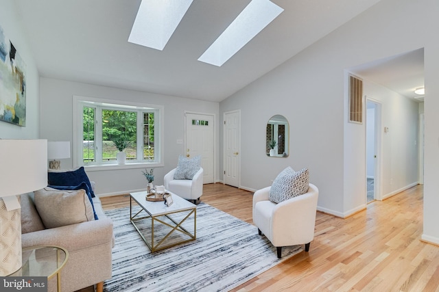 830 Willow Way, Prince Frederick, MD 20678 - living room with a skylight, wood finished floors, baseboards, and high vaulted ceiling