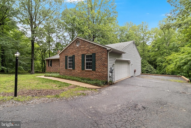 830 Willow Way, Prince Frederick, MD 20678 - view of home's exterior featuring brick siding, asphalt driveway, a garage, a lawn, and roof with shingles