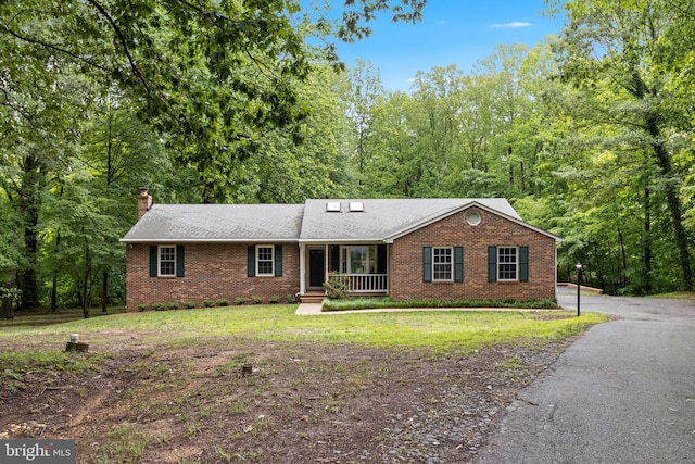 830 Willow Way, Prince Frederick, MD 20678 - ranch-style house with brick siding, a chimney, covered porch, a front yard, and driveway