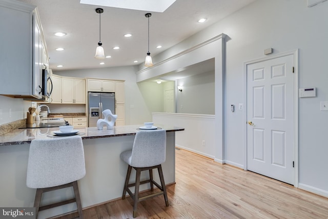 830 Willow Way, Prince Frederick, MD 20678 - kitchen with appliances with stainless steel finishes, a peninsula, light wood-style floors, recessed lighting, and decorative light fixtures