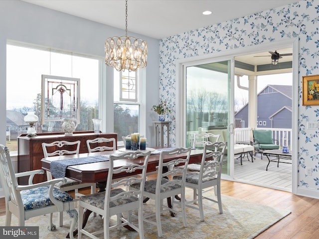 103 Titmouse Ct, Lake Frederick, VA 22630 - dining space with wallpapered walls, light wood finished floors, and a chandelier