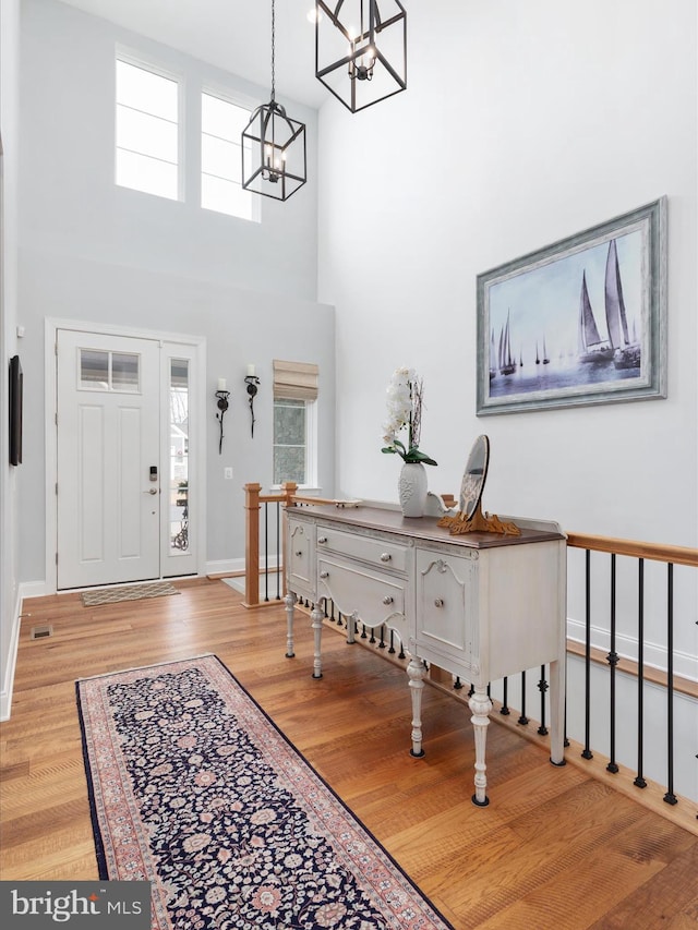103 Titmouse Ct, Lake Frederick, VA 22630 - foyer entrance with a chandelier, wood finished floors, plenty of natural light, baseboards, and a high ceiling