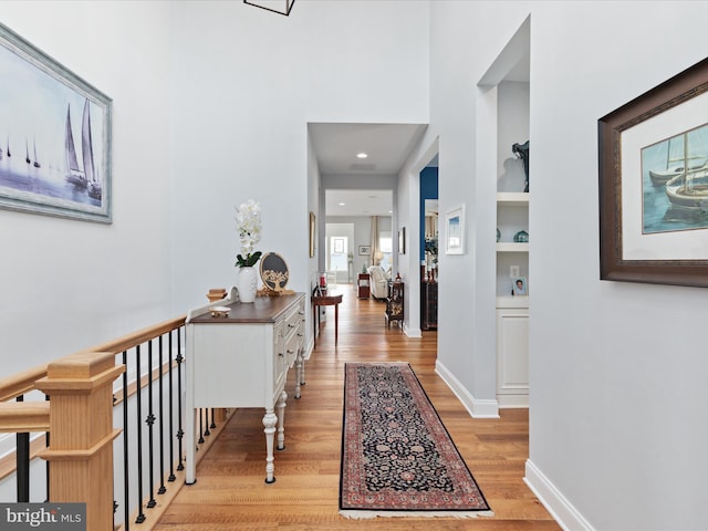 103 Titmouse Ct, Lake Frederick, VA 22630 - hallway featuring light wood finished floors, built in shelves, and baseboards
