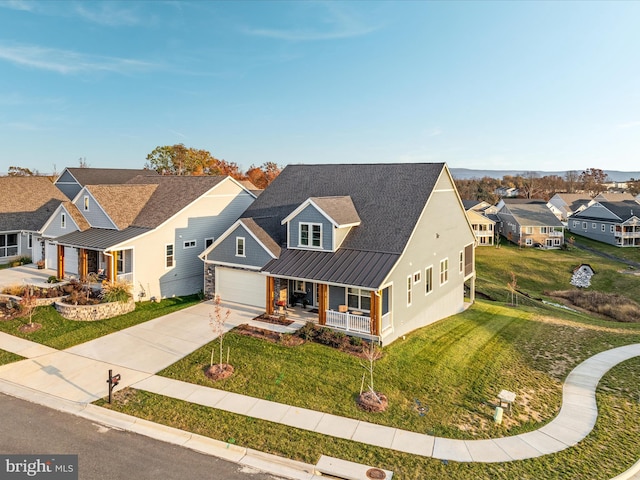 103 Titmouse Ct, Lake Frederick, VA 22630 - view of front of property featuring a porch, a standing seam roof, concrete driveway, a residential view, and a garage