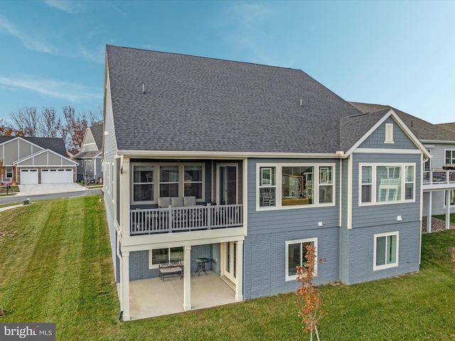 103 Titmouse Ct, Lake Frederick, VA 22630 - rear view of house with a yard, a patio area, brick siding, and roof with shingles