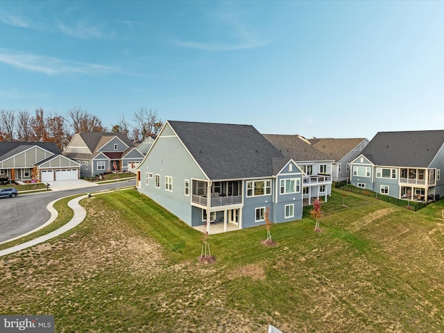 103 Titmouse Ct, Lake Frederick, VA 22630 - back of property with a residential view, a yard, a detached garage, and a shingled roof