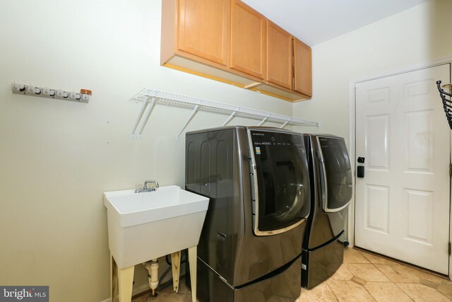 5736 Caribbean Ct, Haymarket, VA 20169 - washroom featuring independent washer and dryer, cabinet space, and light tile patterned floors