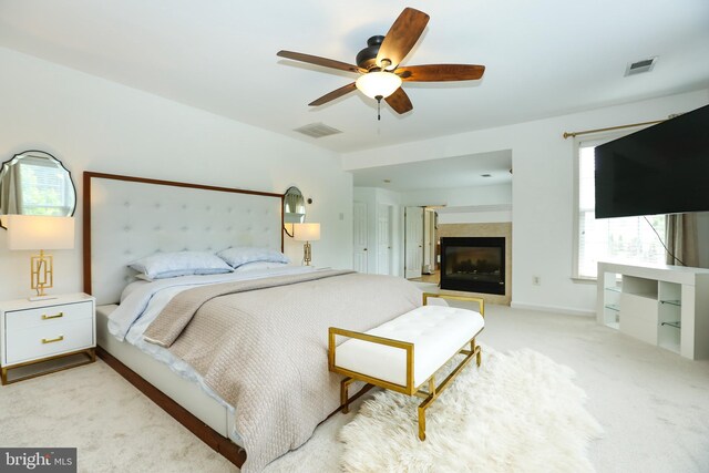 5736 Caribbean Ct, Haymarket, VA 20169 - bedroom with light colored carpet, ceiling fan, and a glass covered fireplace