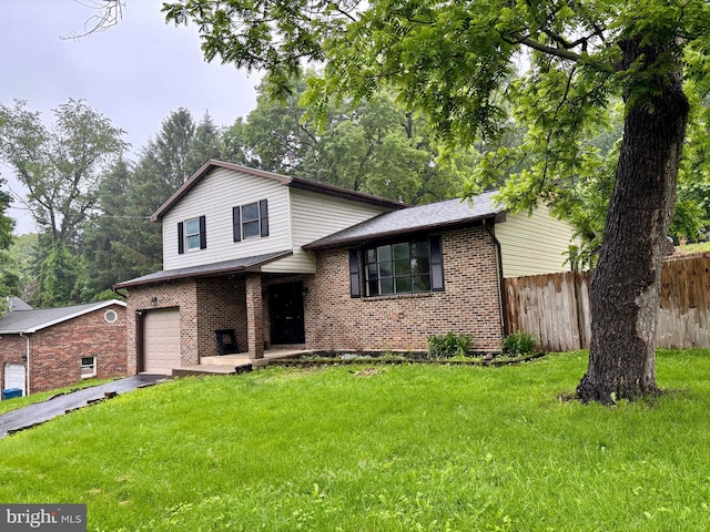 304 Rosedale Ave, Highspire, PA 17034 - tri-level home with brick siding, an attached garage, and driveway