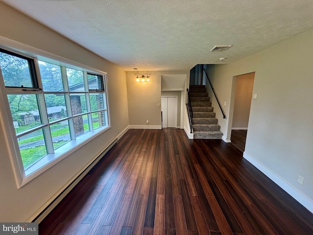 304 Rosedale Ave, Highspire, PA 17034 - unfurnished living room with a textured ceiling, dark wood-style flooring, stairway, baseboards, and a baseboard heating unit