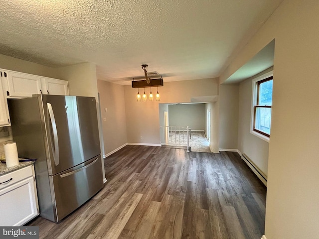 304 Rosedale Ave, Highspire, PA 17034 - kitchen featuring freestanding refrigerator, baseboard heating, dark wood-style floors, white cabinets, and a textured ceiling