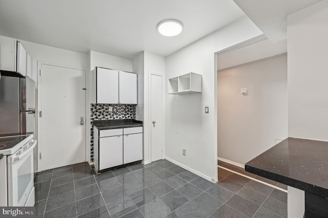 3601 Clarks Ln Unit 424, Baltimore, MD 21215 - kitchen featuring white electric range, granite floors, white cabinets, freestanding refrigerator, and tasteful backsplash