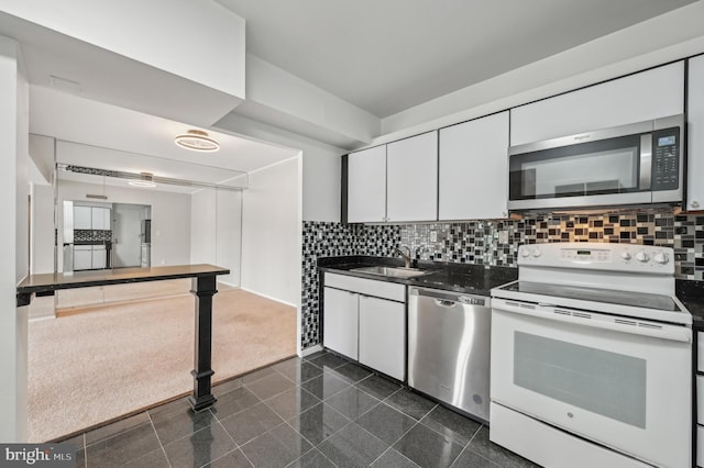 3601 Clarks Ln Unit 424, Baltimore, MD 21215 - kitchen with appliances with stainless steel finishes, granite tiled floors, a sink, and dark countertops