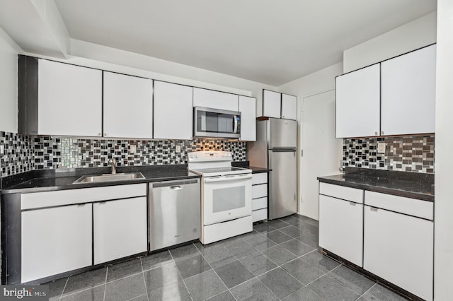 3601 Clarks Ln Unit 424, Baltimore, MD 21215 - kitchen featuring stainless steel appliances, a sink, dark countertops, and white cabinets