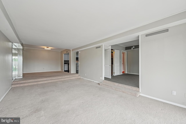 3601 Clarks Ln Unit 424, Baltimore, MD 21215 - unfurnished living room featuring baseboards and carpet floors