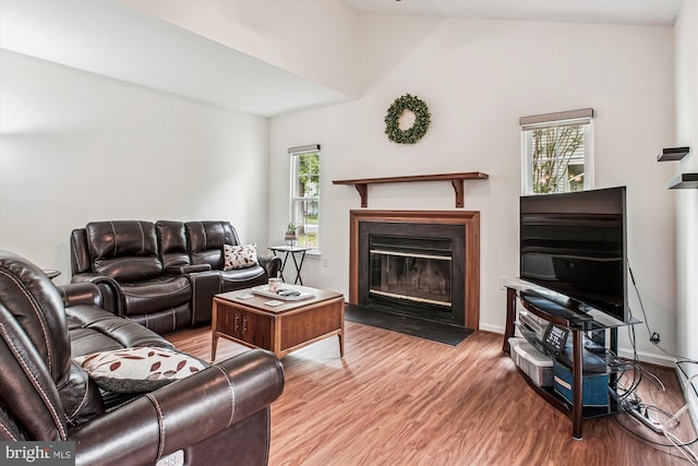 5441 Gladewright Dr, Centreville, VA 20120 - living room with wood finished floors, a fireplace with flush hearth, and lofted ceiling