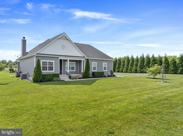 20843 Country Rd, Georgetown, DE 19947 - view of front of property with a front yard, a chimney, and central AC unit