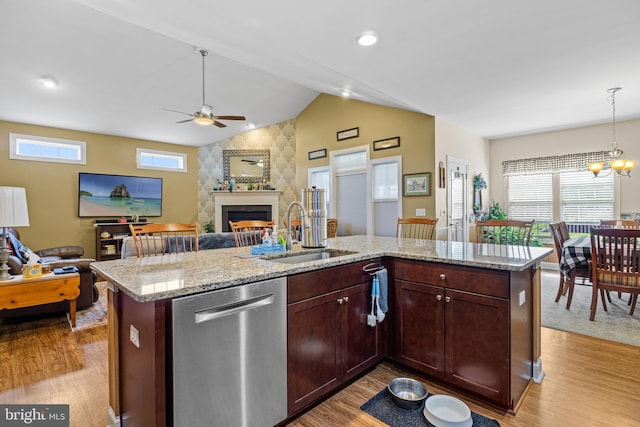 20843 Country Rd, Georgetown, DE 19947 - kitchen featuring dishwasher, a sink, open floor plan, lofted ceiling, and light wood-style flooring