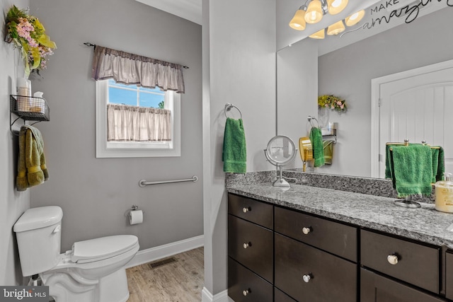 20843 Country Rd, Georgetown, DE 19947 - bathroom featuring toilet, wood finished floors, vanity, and baseboards