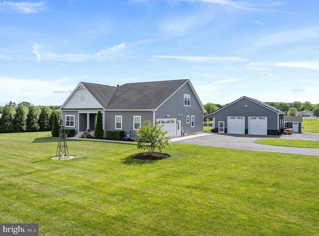 20843 Country Rd, Georgetown, DE 19947 - view of front facade with a front lawn, a garage, roof with shingles, and an outbuilding