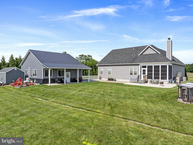 20843 Country Rd, Georgetown, DE 19947 - back of house featuring a patio area, entry steps, a chimney, and a lawn