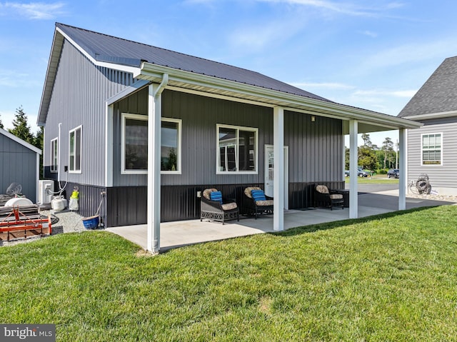 20843 Country Rd, Georgetown, DE 19947 - rear view of house featuring a patio, a yard, and metal roof