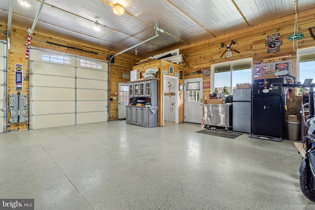20843 Country Rd, Georgetown, DE 19947 - garage featuring freestanding refrigerator and wood walls