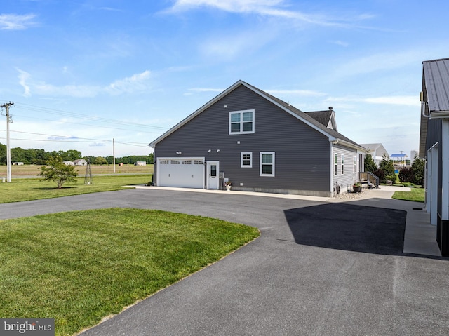 20843 Country Rd, Georgetown, DE 19947 - view of side of home featuring a yard and asphalt driveway