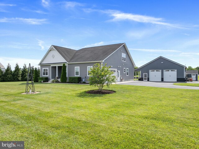20843 Country Rd, Georgetown, DE 19947 - view of front of home with a detached garage, an outdoor structure, a front yard, and a shingled roof