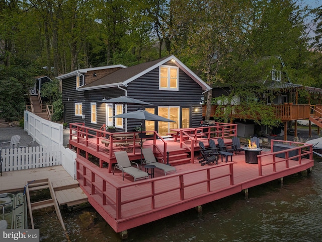 36 S Lake Dr, Lake Harmony, PA 18624 - back of property with a deck with water view, an outdoor fire pit, and stairway