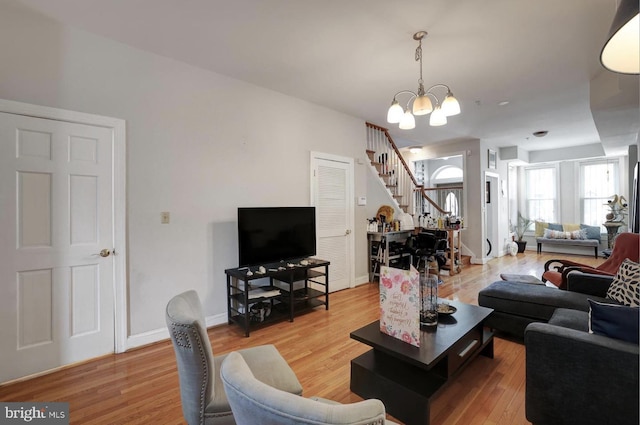 1316 Irving St NW, Washington, DC 20010 - living area featuring stairs, a chandelier, light wood-style floors, and baseboards