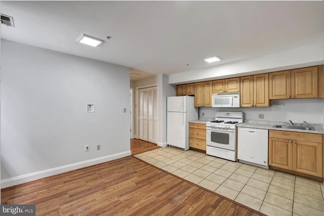 1316 Irving St NW, Washington, DC 20010 - kitchen featuring white appliances, light wood-style flooring, light countertops, baseboards, and a sink