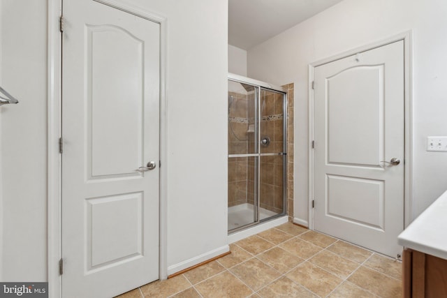 8609 Wintergreen Ct Unit 304, Odenton, MD 21113 - full bath featuring a stall shower, vanity, baseboards, and tile patterned floors