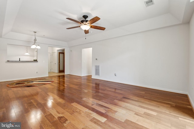 8609 Wintergreen Ct Unit 304, Odenton, MD 21113 - unfurnished living room with ceiling fan, baseboards, wood finished floors, and a tray ceiling