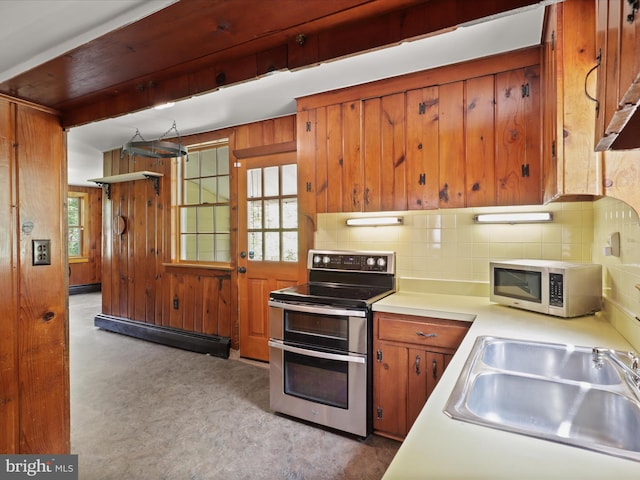 8301 Crestridge Rd, Fairfax Station, VA 22039 - kitchen featuring stainless steel appliances, tasteful backsplash, light countertops, brown cabinetry, and a baseboard heating unit