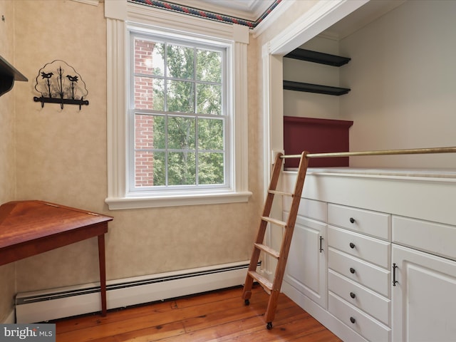 8301 Crestridge Rd, Fairfax Station, VA 22039 - walk in closet with baseboard heating and wood-type flooring