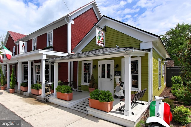 8301 Crestridge Rd, Fairfax Station, VA 22039 - view of front of house with a standing seam roof, covered porch, and a metal roof