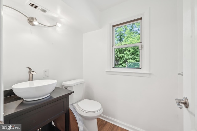 7715 Doe Ln, Glenside, PA 19038 - half bath with wood finished floors, toilet, vanity, and baseboards
