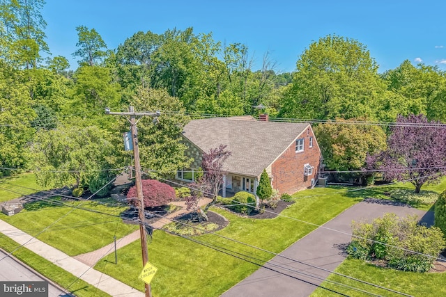 7715 Doe Ln, Glenside, PA 19038 - view of front of home with a front yard, a chimney, driveway, and brick siding
