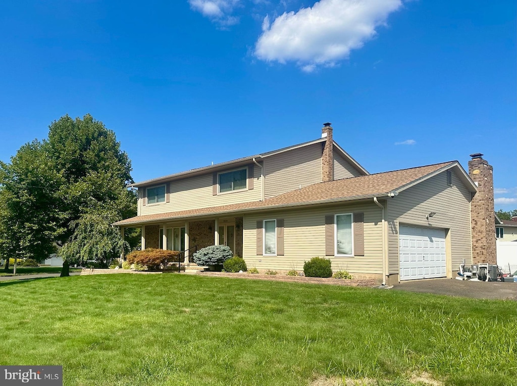3524 Klockner, Hamilton, NJ 08690 - traditional home with an attached garage, driveway, a front yard, and a chimney