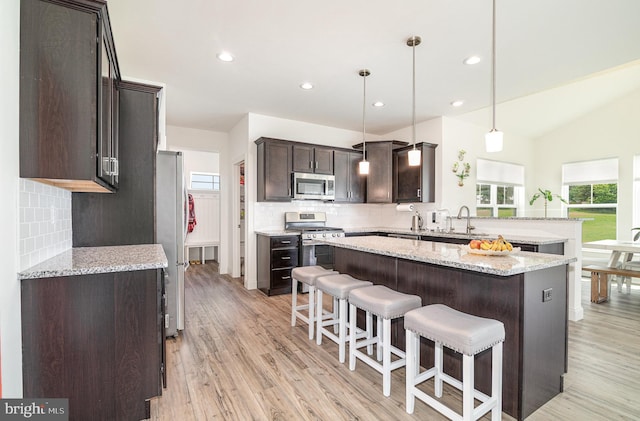 6320 Neha Dr, Mechanicsburg, PA 17050 - kitchen featuring appliances with stainless steel finishes, tasteful backsplash, dark brown cabinets, light wood-style flooring, and recessed lighting